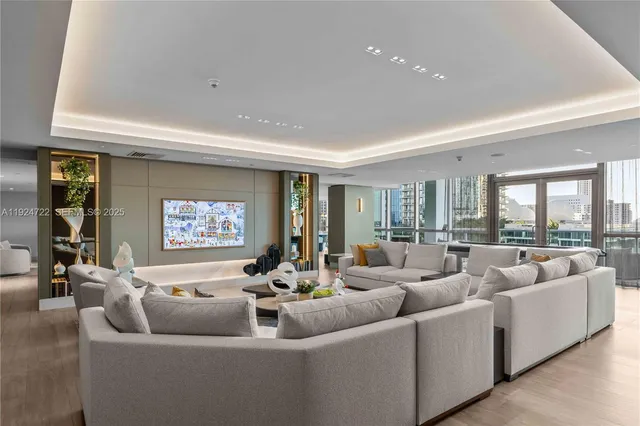 a living room with furniture and a large window