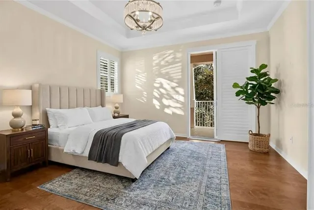 a bedroom with a large bed and a potted plant