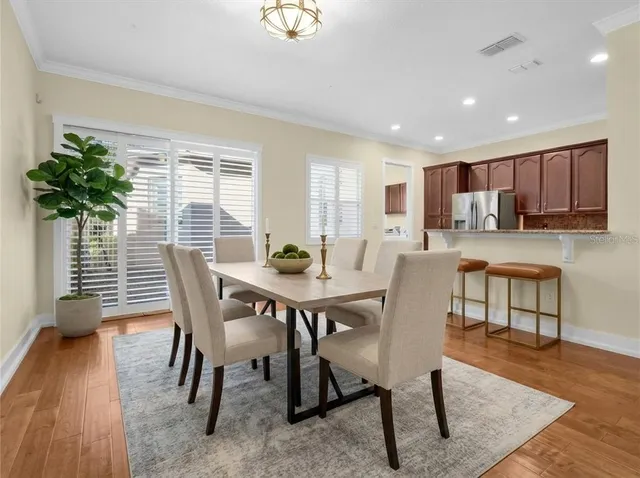 a view of a dining room with furniture and wooden floor