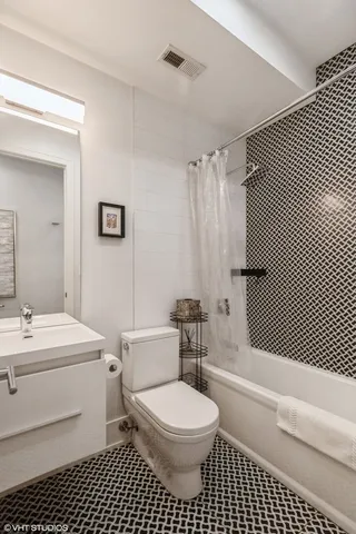 a bathroom with a toilet a sink and a shower