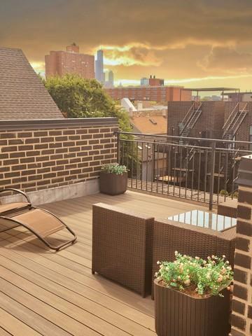 1543 West Augusta Boulevard, Unit 2 Chicago, IL 60642 - Photo 18 of 21 a view of a balcony with two chairs and a table