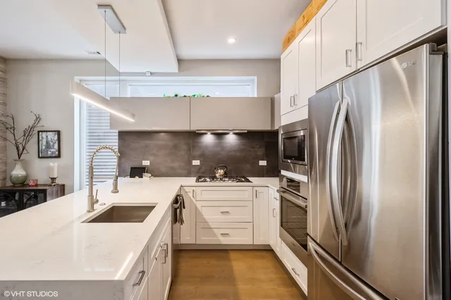 a kitchen with a sink a refrigerator and a stove