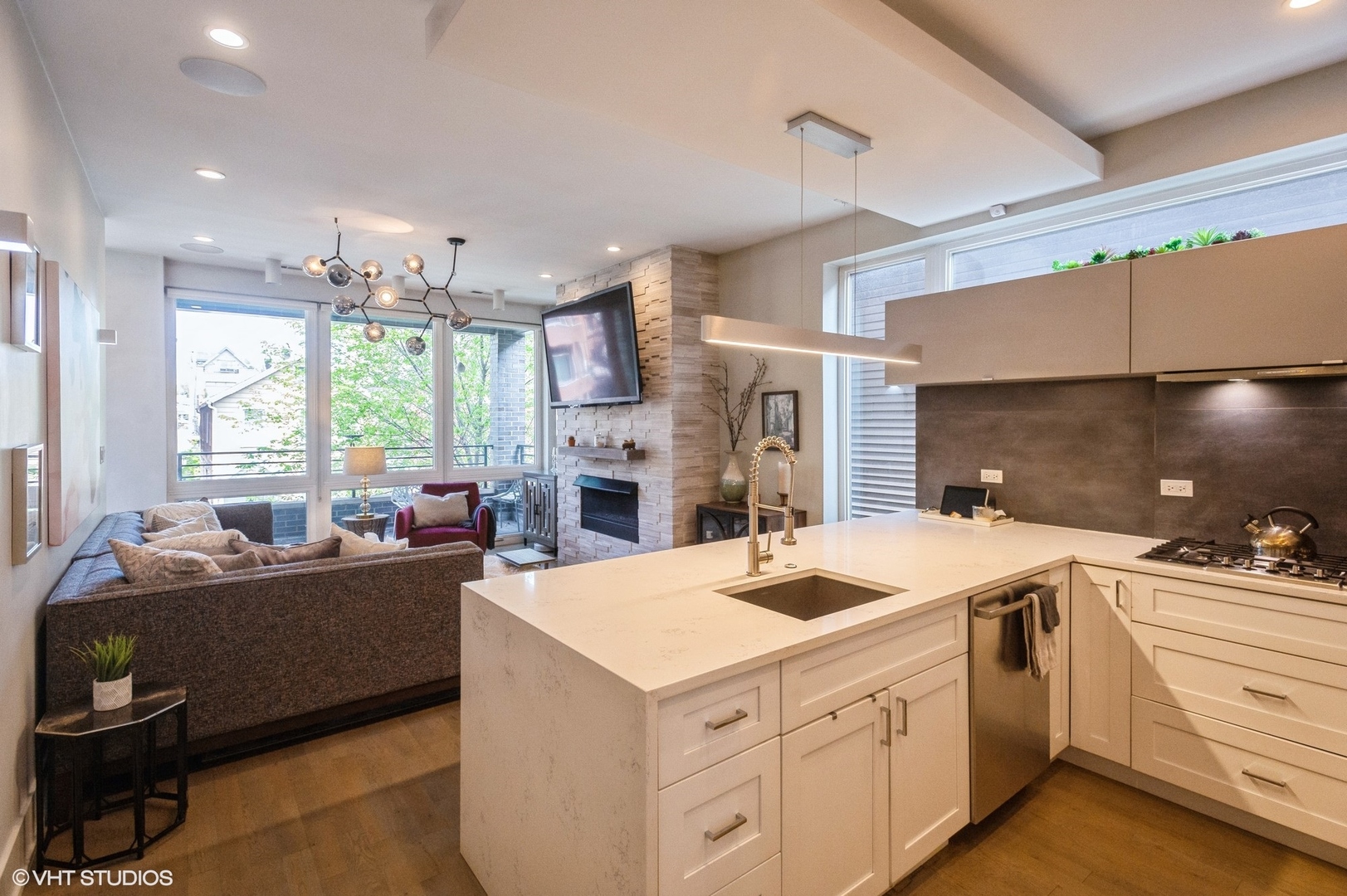 1543 West Augusta Boulevard, Unit 2 Chicago, IL 60642 - Photo 5 of 21 a kitchen that has a sink a stove and a table in it