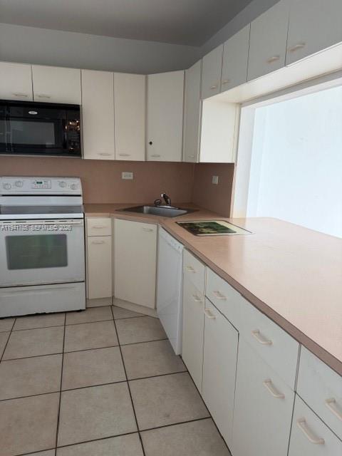 5601 Collins Avenue, Unit 607 Miami Beach, FL 33140 - Photo 15 of 22 a kitchen with a sink and cabinets