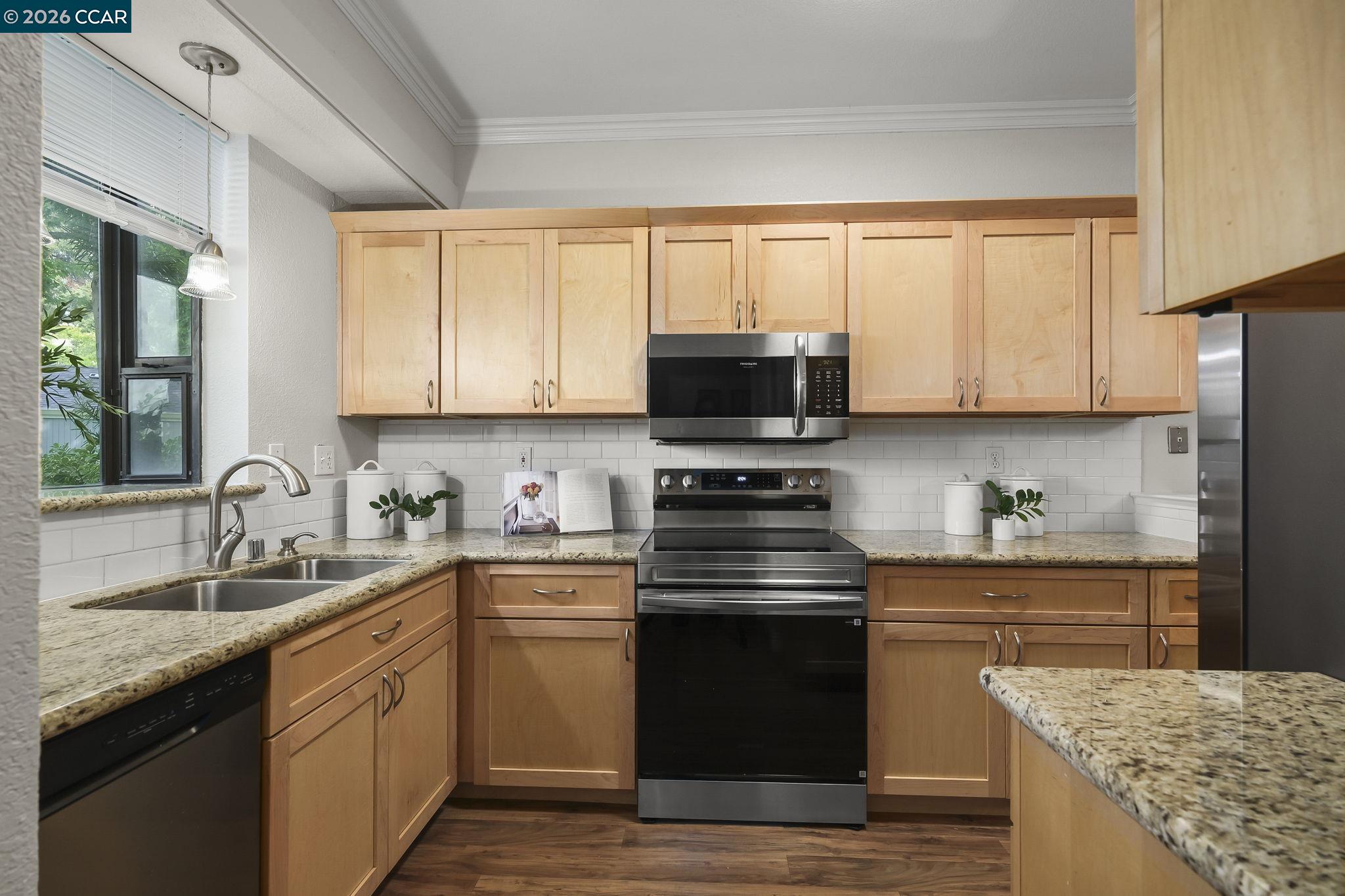 2586 Oak Road, Unit 130 Walnut Creek, CA 94597 - Photo 11 of 31 a kitchen with stainless steel appliances granite countertop a stove a sink dishwasher and a microwave oven with cabinets