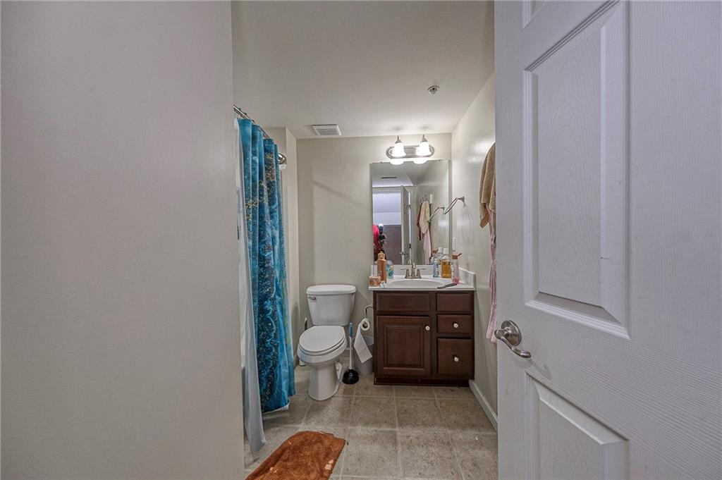 137 Lewisham Road Cranberry Township, PA 16066 - Photo 12 of 16 a en suite bathroom with a granite countertop sink toilet and a mirror