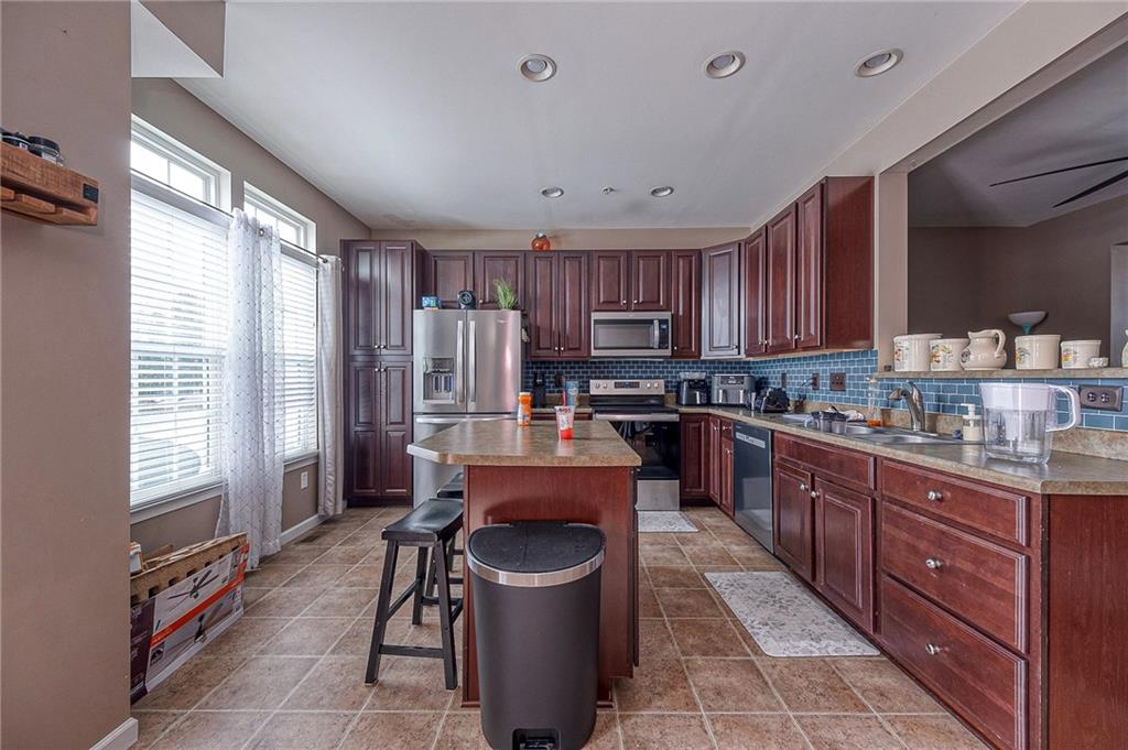 137 Lewisham Road Cranberry Township, PA 16066 - Photo 5 of 16 a open kitchen with stainless steel appliances granite countertop a stove top oven a sink dishwasher and cabinets