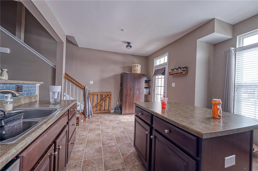 137 Lewisham Road Cranberry Township, PA 16066 - Photo 6 of 16 a kitchen with stainless steel appliances granite countertop a sink and a refrigerator