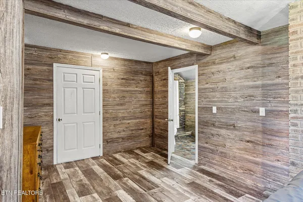 a bedroom with a bed closet and flat tv screen