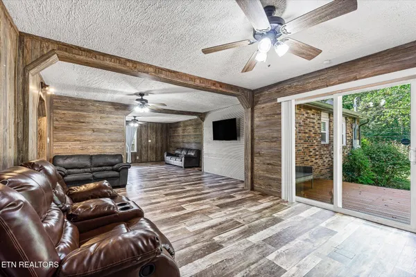 a view of a livingroom with wooden floor and a fireplace