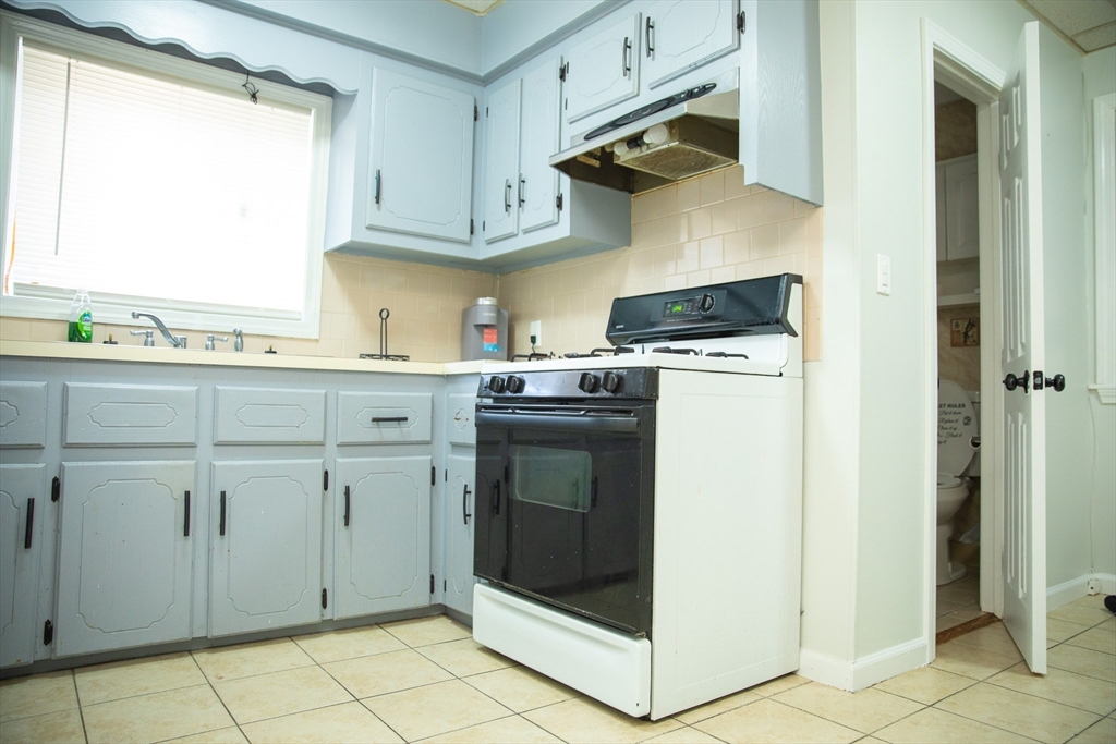 a kitchen with stainless steel appliances white cabinets and a sink
