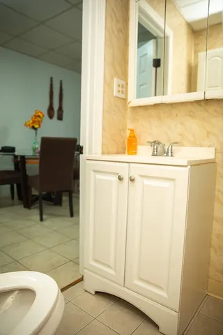 a bathroom with a sink toilet and mirror