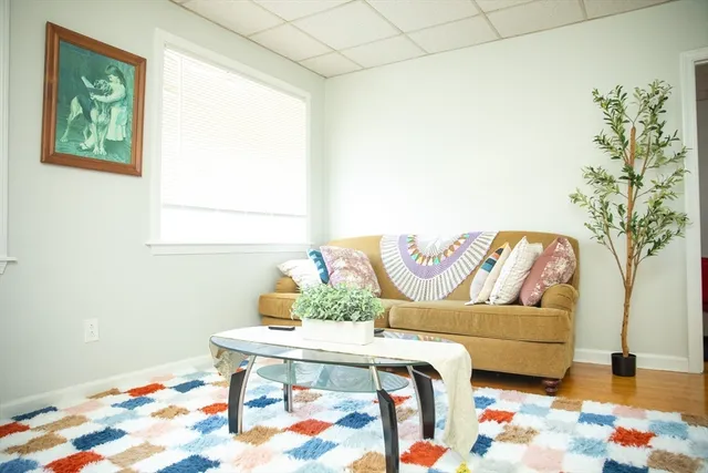 a living room with furniture and flowers
