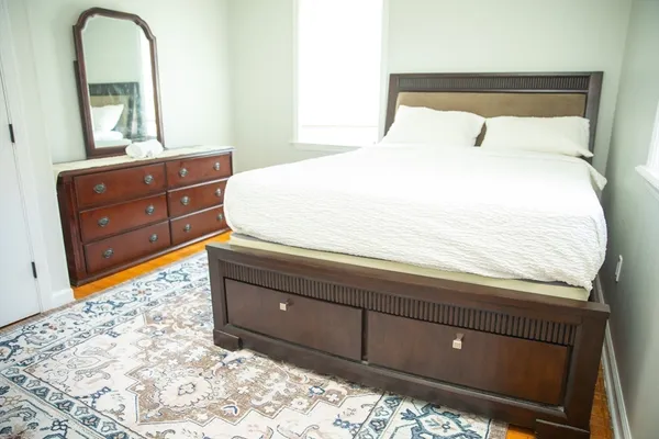 a bedroom with a bed and a dresser