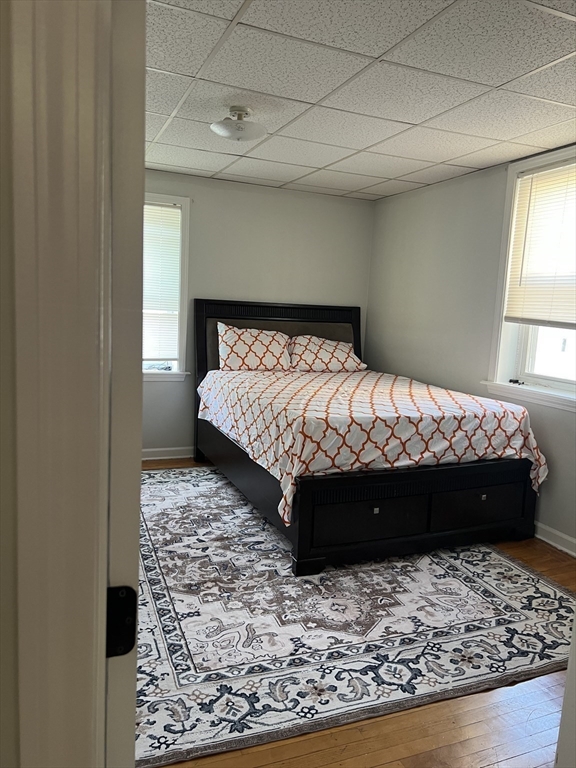 255 Columbia Street, Unit 2 Fall River, MA 02721 - Photo 7 of 15 a bed sitting in a bedroom next to a window with a lamp