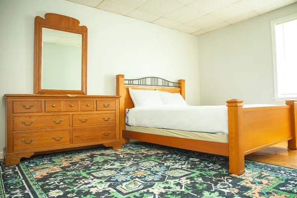 a bedroom with a bed and a dresser