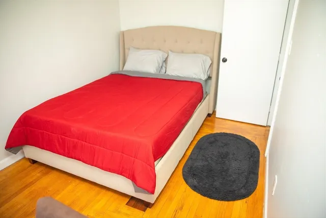 a bedroom with a bed and a lamp