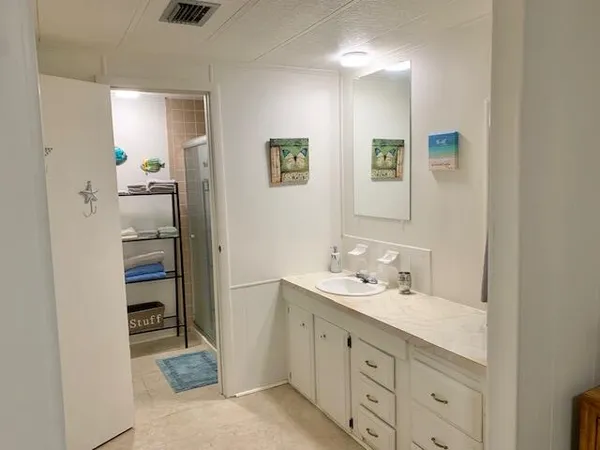 a view of a dining room with furniture one side and wooden floor