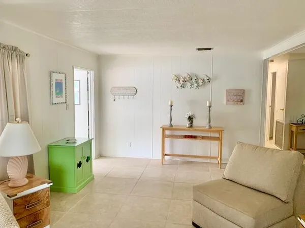 a view of a patio with table and chairs under an umbrella with a fire pit