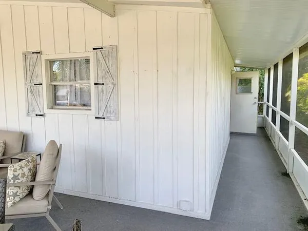 a view of a hallway with furniture