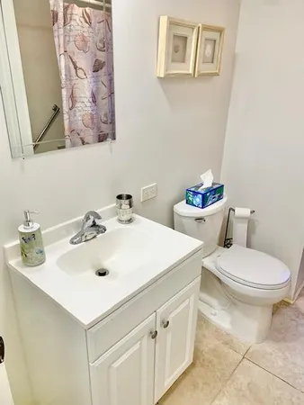 a white toilet sitting next to a shower curtain