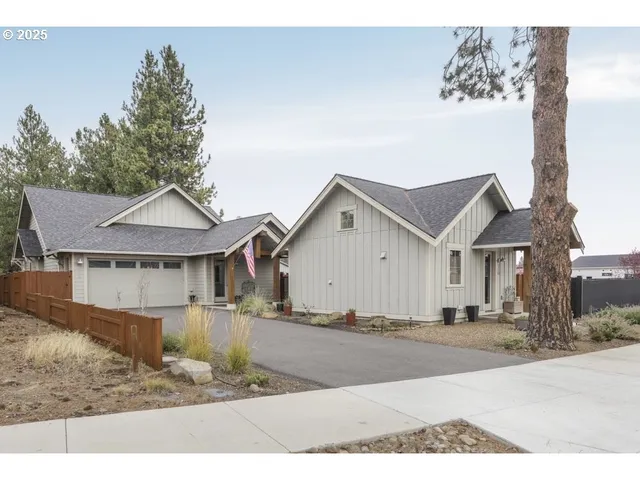 a view of a house with a yard and fence