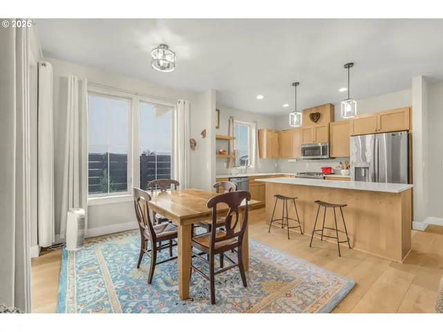 a dining room with furniture and wooden floor