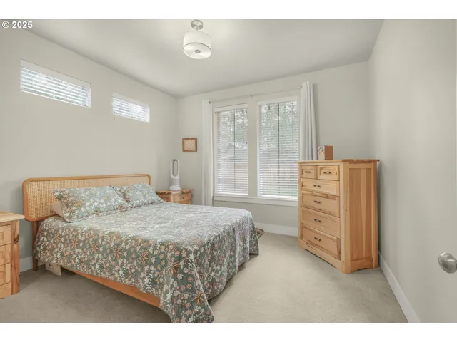 a bathroom with a double vanity sink a mirror and a shower