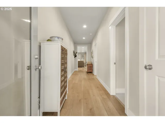 a view of a hallway with wooden floor