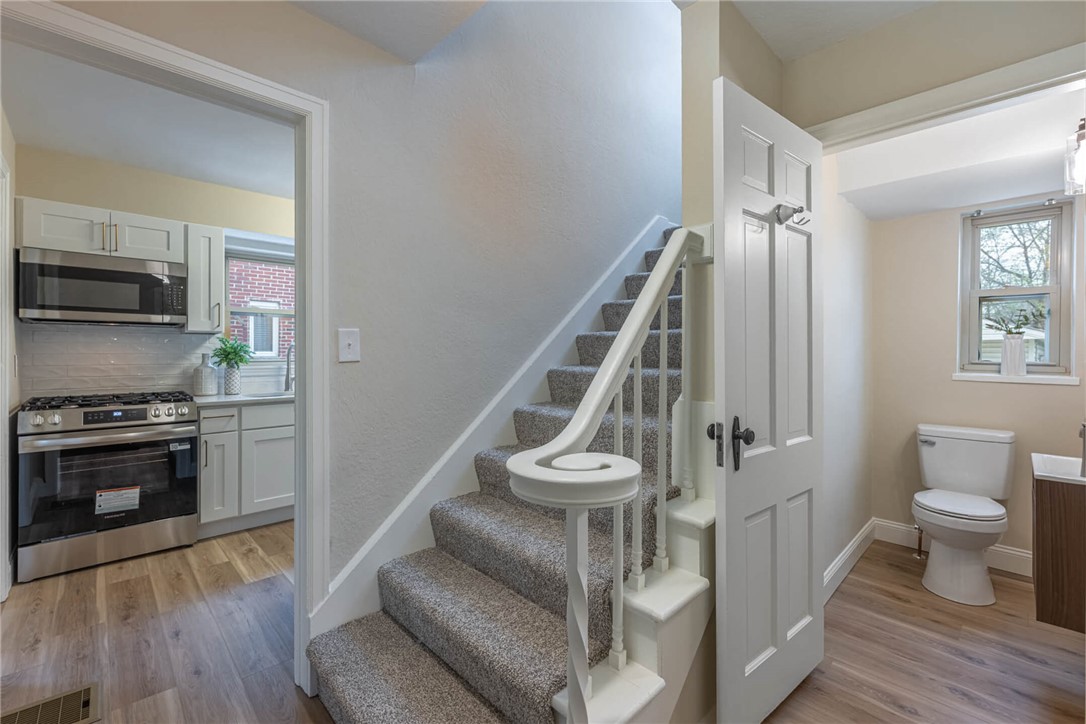 1012 Hampshire Road Dayton, OH 45419 - Photo 18 of 39 This interior image highlights a staircase and parts of a kitchen and bathroom.