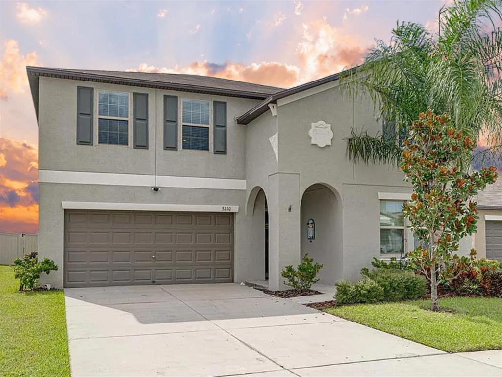 5210 Dandelion Street Apollo Beach, FL 33572 - Photo 1 of 1 a front view of a house with garden