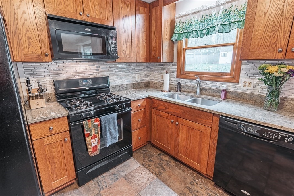 26 Hunter Avenue Hudson, MA 01749 - Photo 12 of 42 a kitchen with stainless steel appliances granite countertop a sink stove and microwave