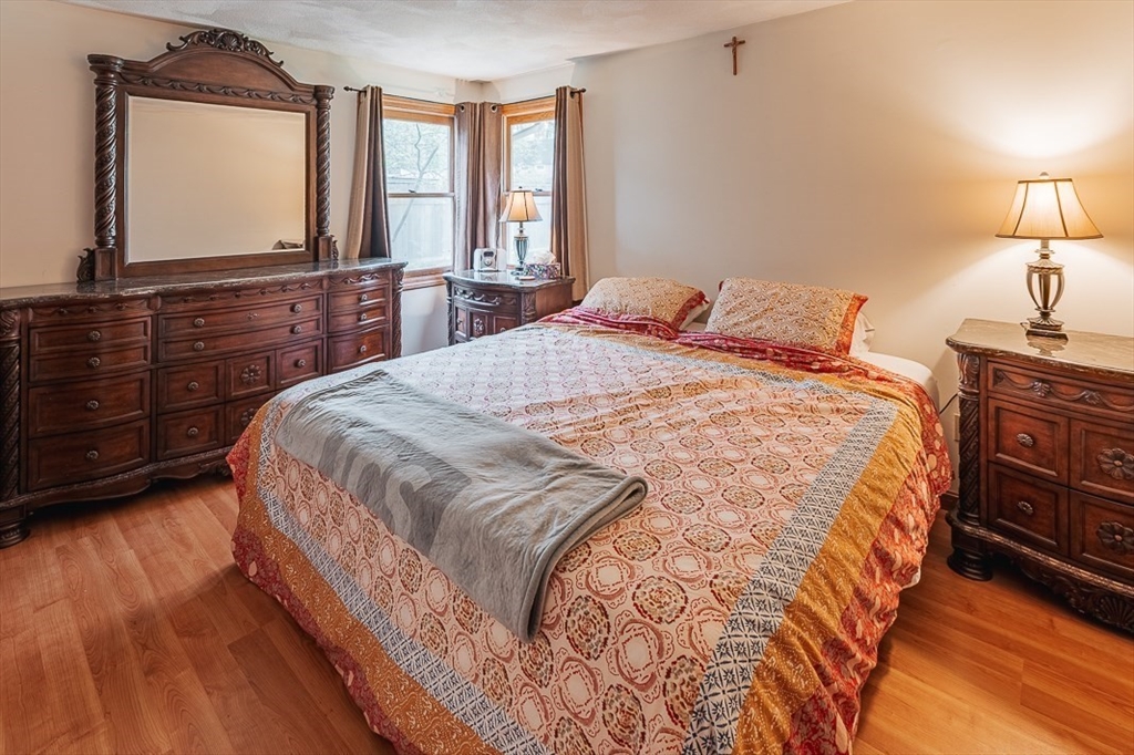 26 Hunter Avenue Hudson, MA 01749 - Photo 18 of 42 a bedroom with a bed a dresser and wooden floor