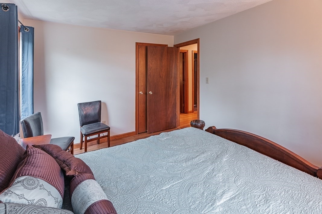 26 Hunter Avenue Hudson, MA 01749 - Photo 23 of 42 a bedroom with a bed and a chair