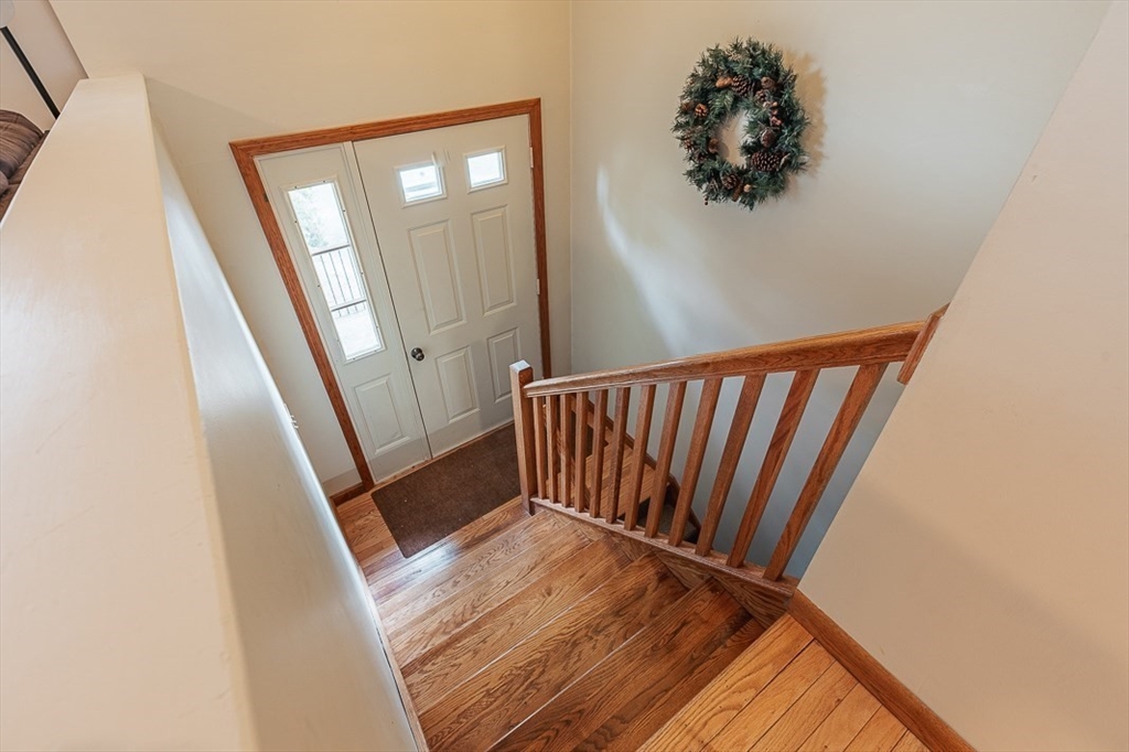 26 Hunter Avenue Hudson, MA 01749 - Photo 24 of 42 a view of a hallway with wooden floor and staircase