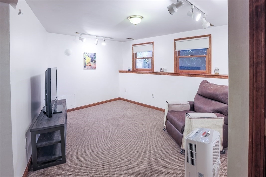 26 Hunter Avenue Hudson, MA 01749 - Photo 28 of 42 a living room with furniture and a flat screen tv