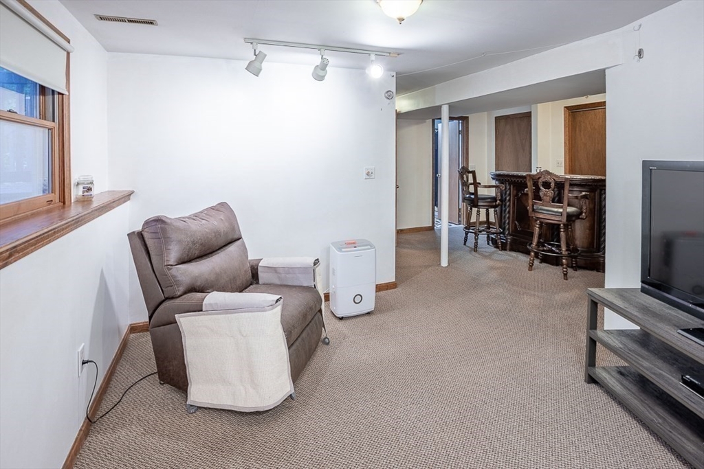 26 Hunter Avenue Hudson, MA 01749 - Photo 29 of 42 a living room with furniture and a flat screen tv