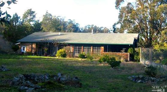 a view of a house with garden and trees