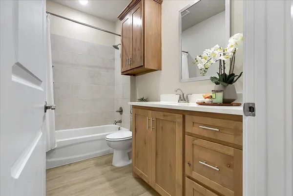 an empty room with a chandelier fan and windows
