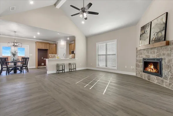 a view of a livingroom with furniture a ceiling fan and windows