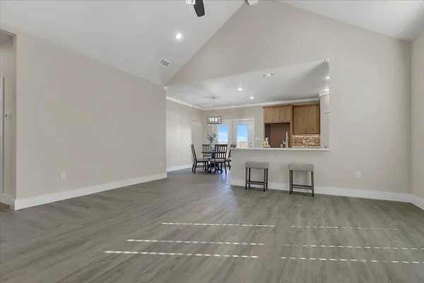 a view of a room with chairs and wooden floor