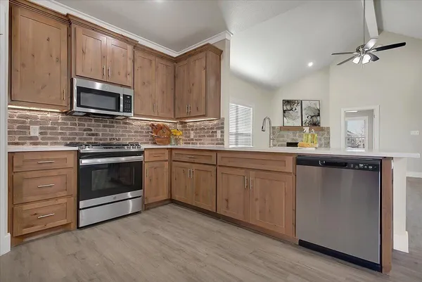 a kitchen with a sink stove and microwave