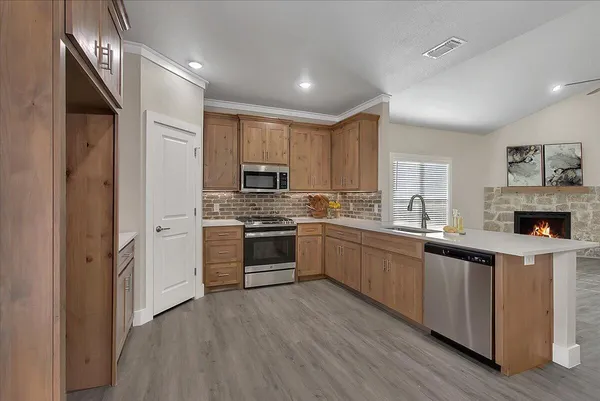 a kitchen with a refrigerator stove top oven and sink