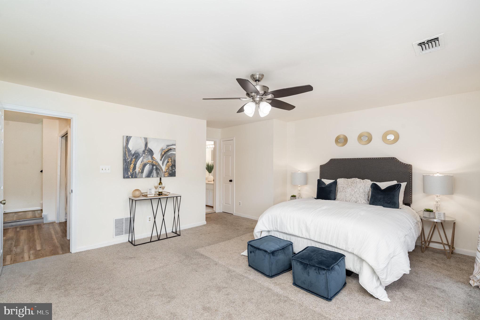 4068 Chetham Way Woodbridge, VA 22192 - Photo 17 of 27 a bedroom with a bed and a chandelier