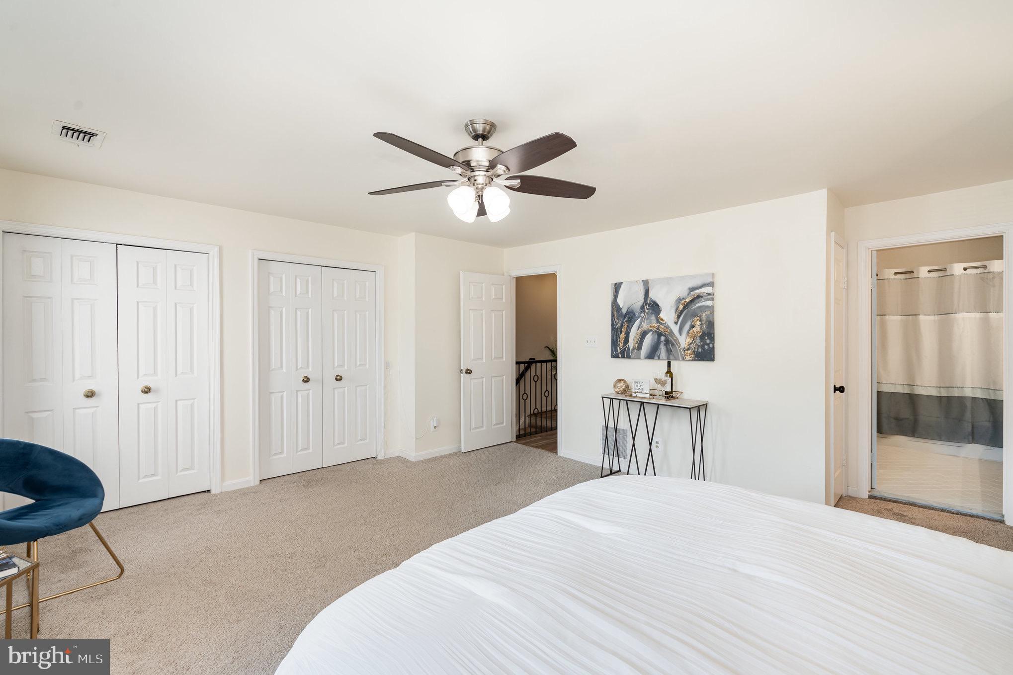 4068 Chetham Way Woodbridge, VA 22192 - Photo 19 of 27 a bedroom with a bed and a chandelier