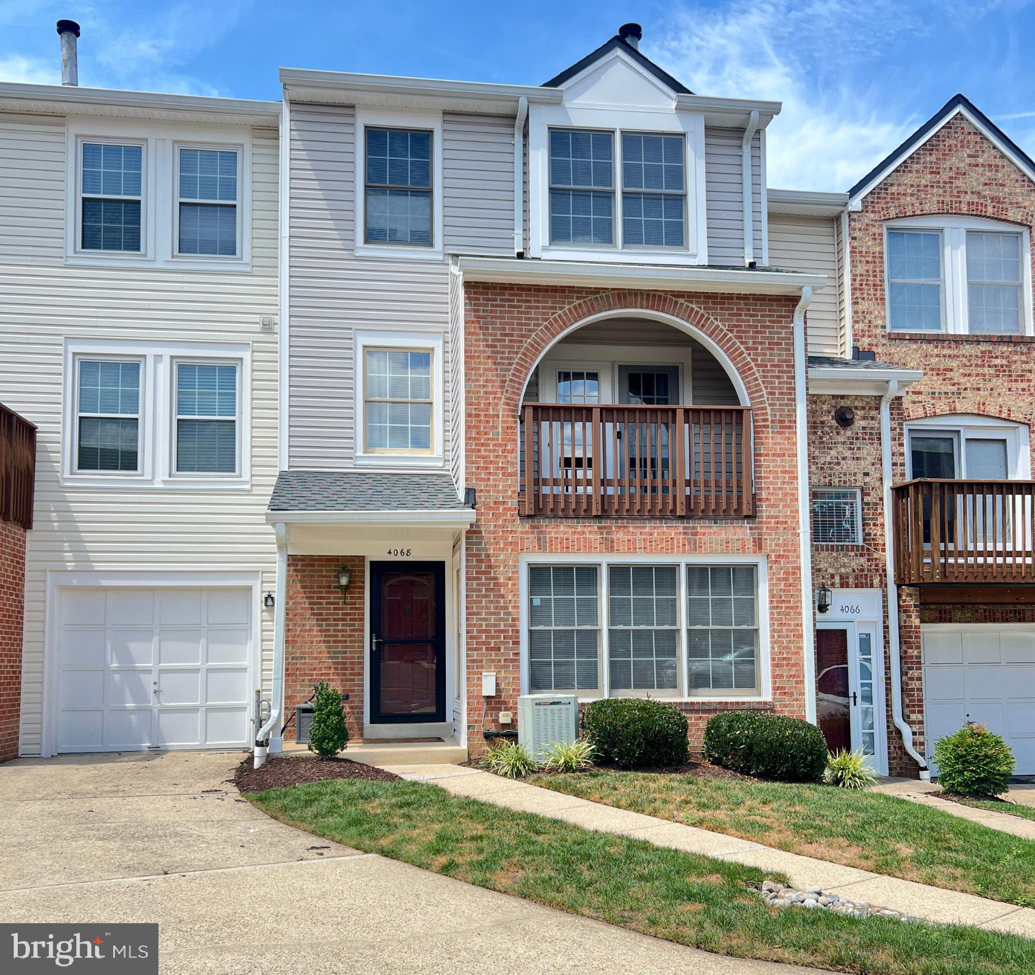 4068 Chetham Way Woodbridge, VA 22192 - Photo 2 of 27 a front view of a house with garden