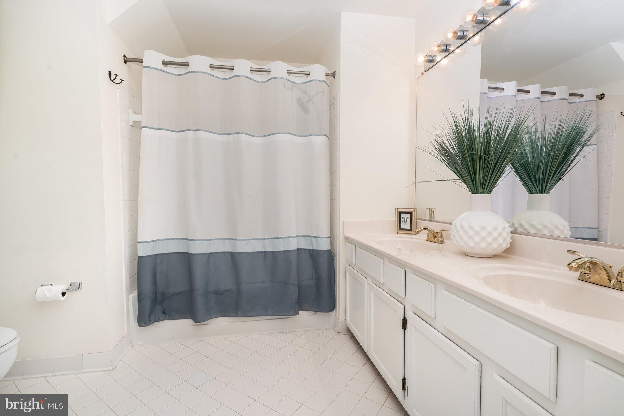 4068 Chetham Way Woodbridge, VA 22192 - Photo 21 of 27 a bathroom with a double vanity sink and a mirror