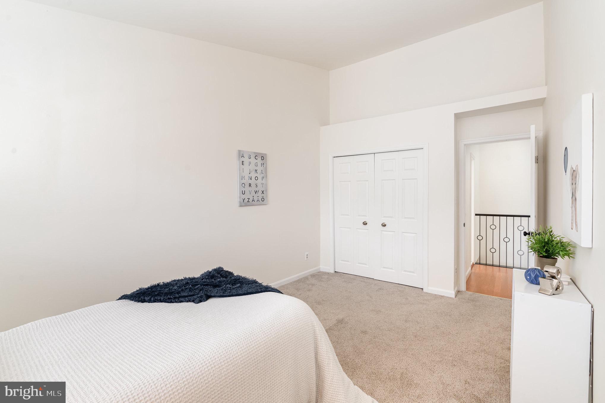 4068 Chetham Way Woodbridge, VA 22192 - Photo 25 of 27 a bedroom with a bed and a potted plant