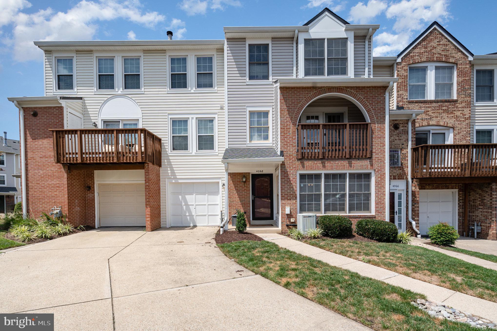 4068 Chetham Way Woodbridge, VA 22192 - Photo 3 of 27 a front view of a house with a yard