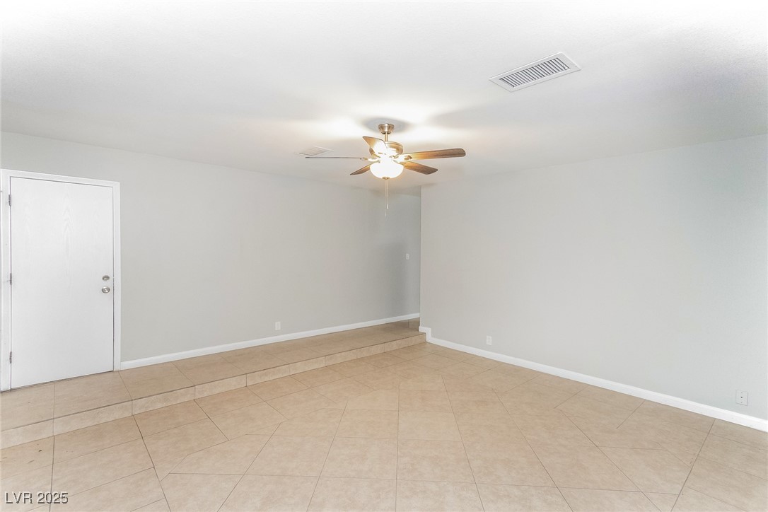 4737 Monaco Road Las Vegas, NV 89121 - Photo 7 of 21 Spare room featuring ceiling fan and baseboards